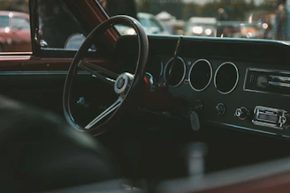 A close-up of a rare vintage car's gleaming dashboard under soft lighting.