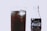 A close-up view of a glass filled with a dark, fizzy liquid and ice cubes. Next to the glass, there is a Coca-Cola bottle with the original taste label visible on it.
