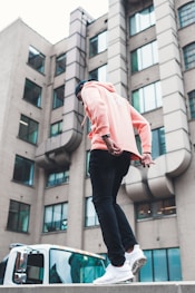 man walking near vehicle and building