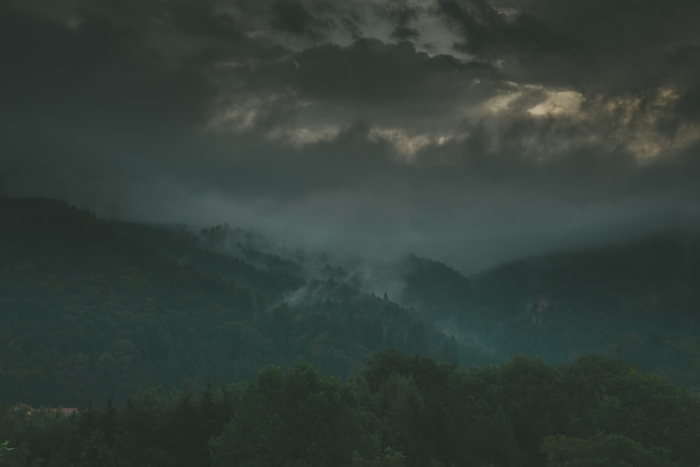 green mountains under gray clouds