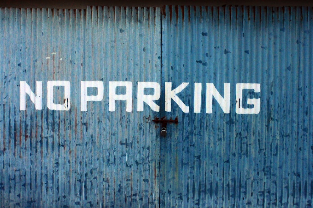 blue and white No Parking printed wall