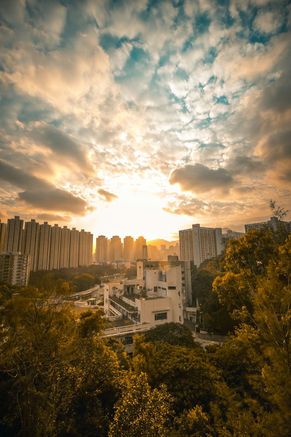 high-angle photography of high-rise building under nimbus clouds