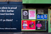 posters mounted on building wall during daytime