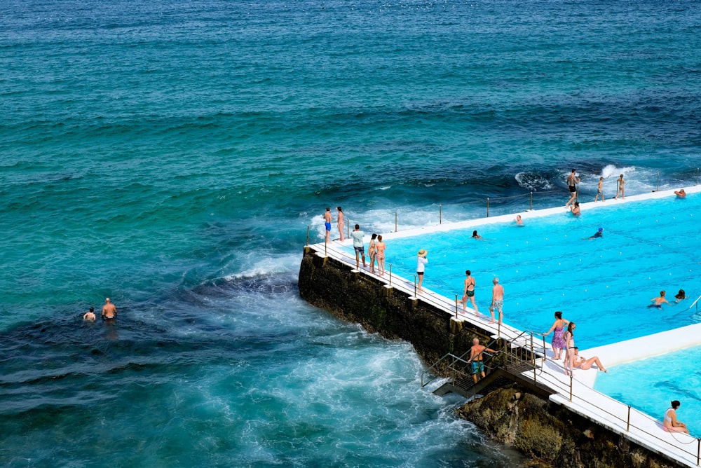 people at pool near ocean