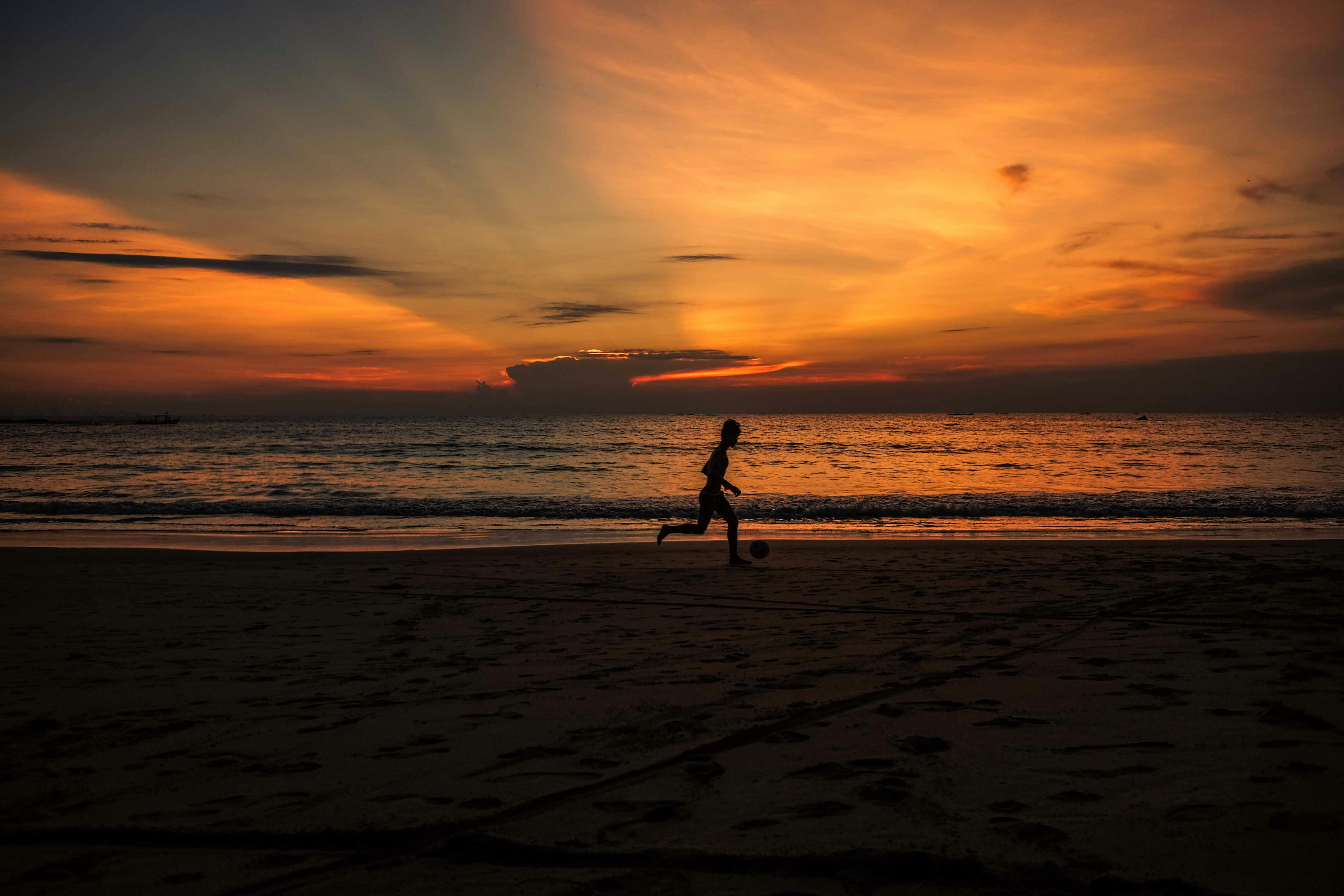 silhouette photo of person running near the shore