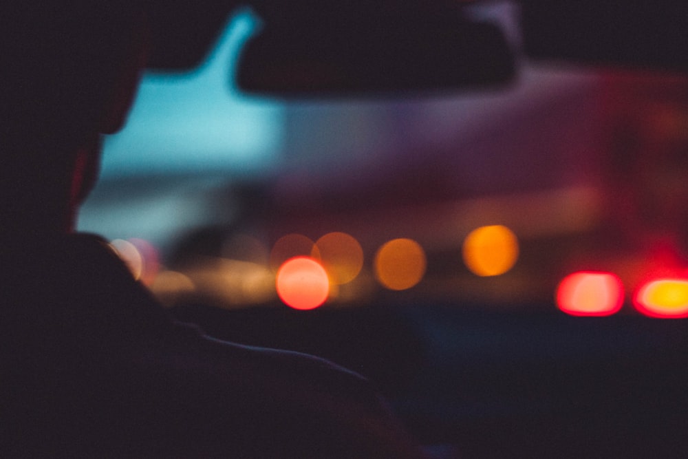 a blurry photo of a person in a car at night