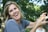 A smiling person celebrating their smoke-free life outdoors.