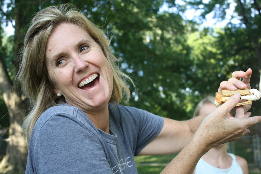 woman holding sandwich