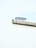 Back of a smartphone showcasing its camera module against a plain white background.