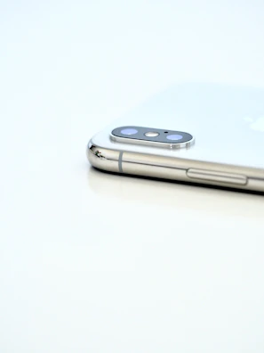 Back of a smartphone showcasing its camera module against a plain white background.