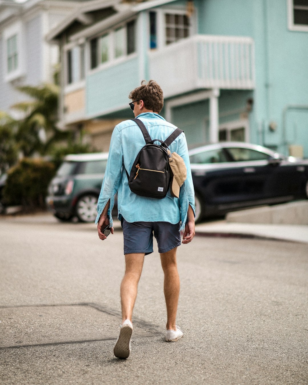 man walking wearing blue dress shirt