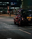 black vehicle on gray concrete road during nighttime