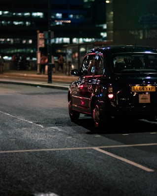 black vehicle on gray concrete road during nighttime