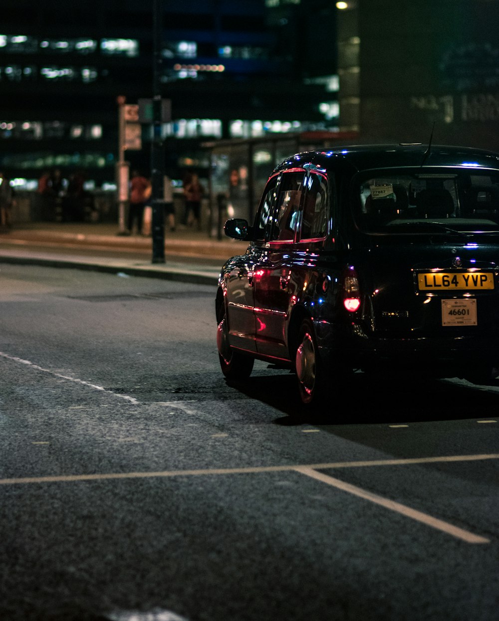 black vehicle on gray concrete road during nighttime