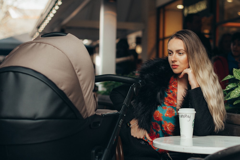 woman looking at black and brown stroller