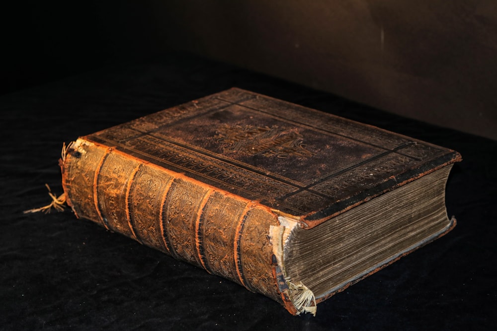 brown hardbound book on table