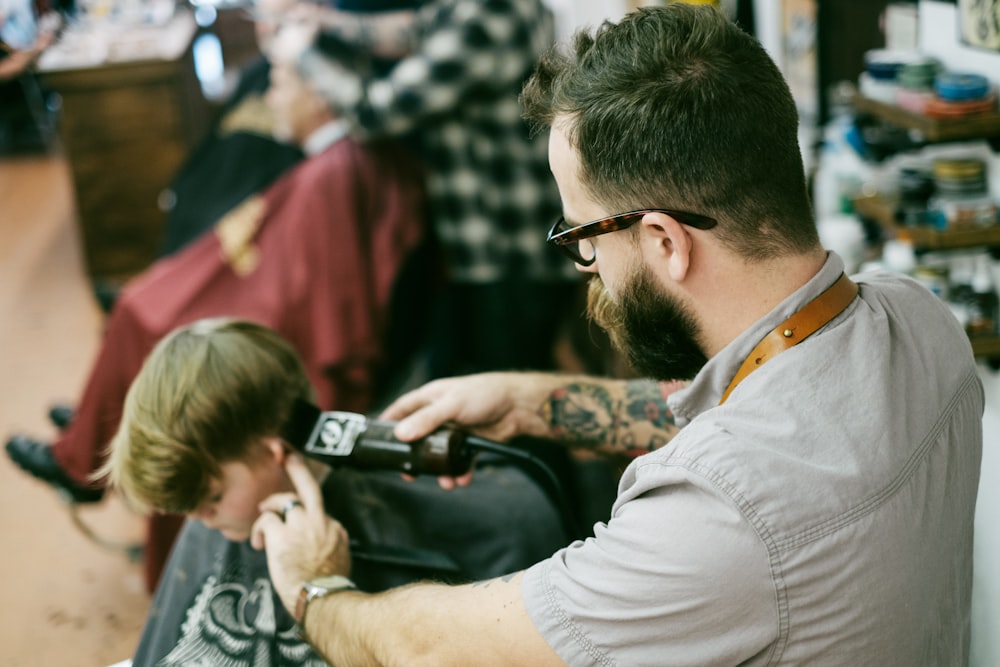 man shaving the boy's hair