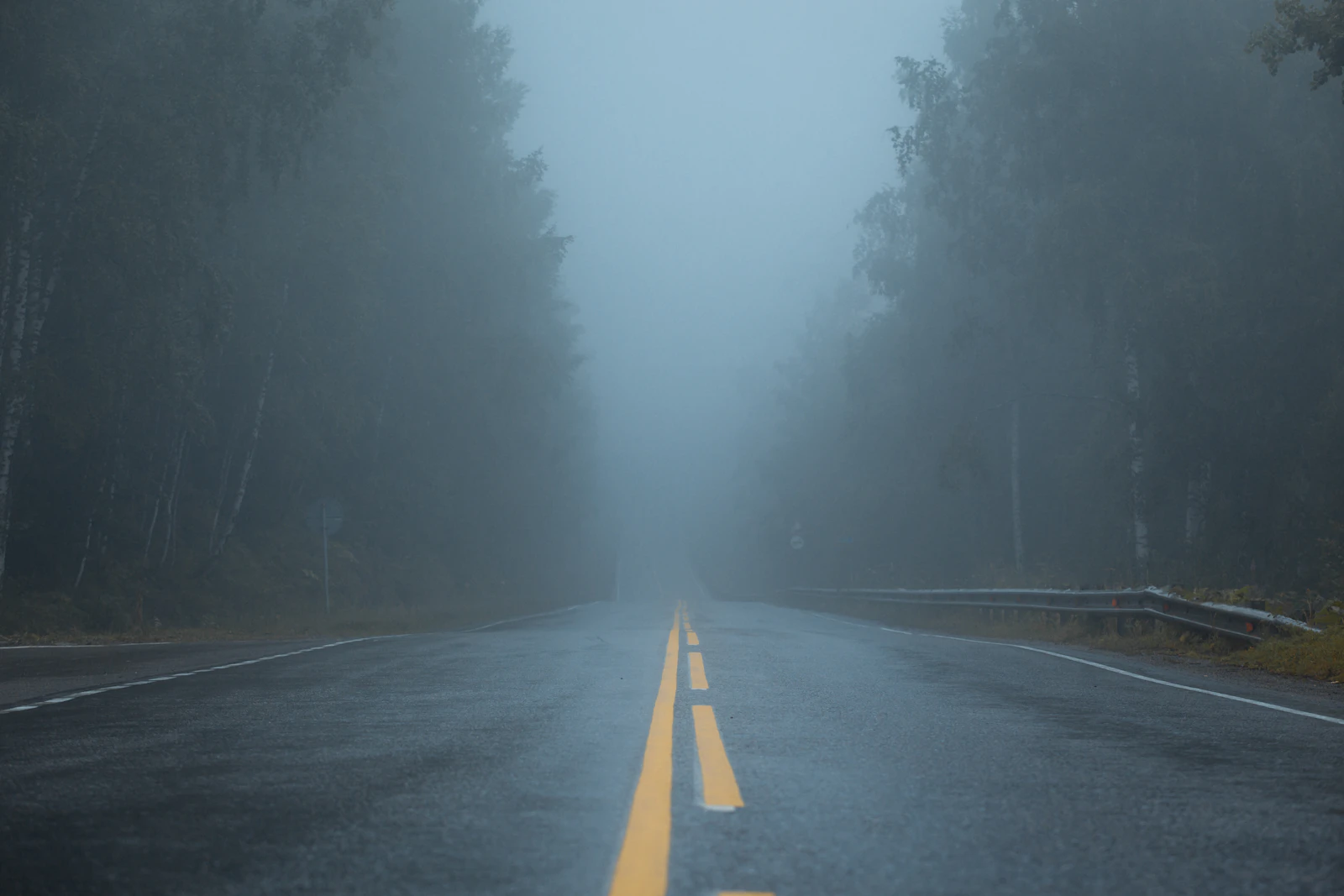 A foggy road stretching ahead with no visible end point, representing the open-ended structure infinite scroll needs a stable, unique URL underneath every stretch of content to stay indexable