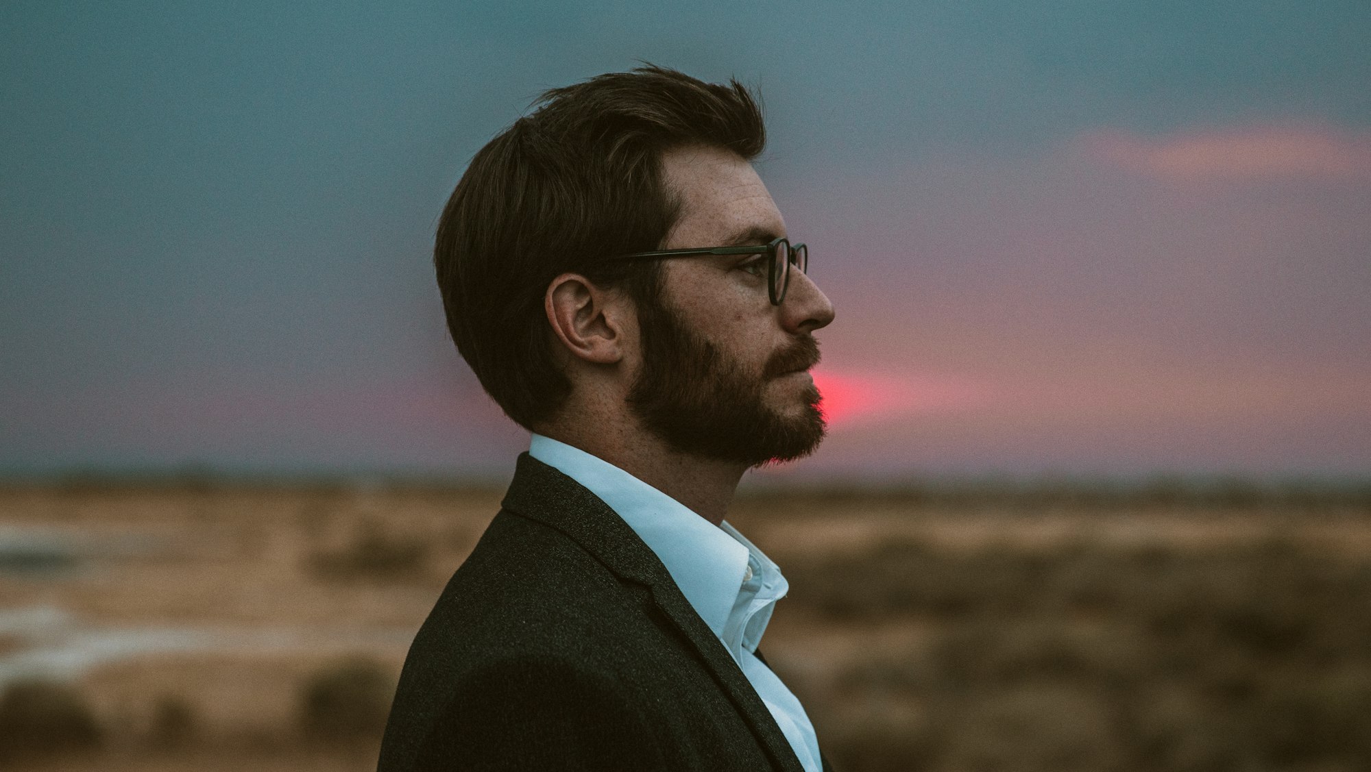 Man stares and he glasses and has beard, nice