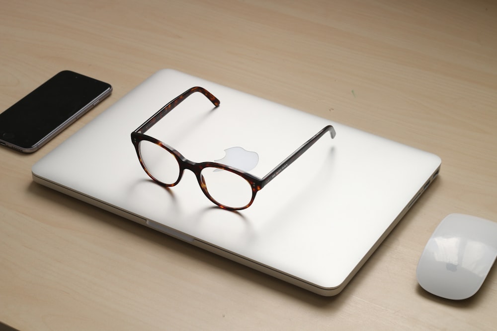 tortoiseshell framed sunglasses on silver MacBook