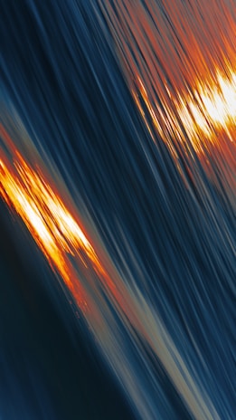 a blurry photo of the sun setting over a body of water