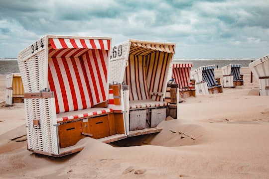 assorted-color chairs on shore during daytime in Baltrum Germany