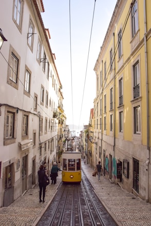 yellow and grey vehicle passing on road