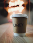 selective focus photography of white disposable cup