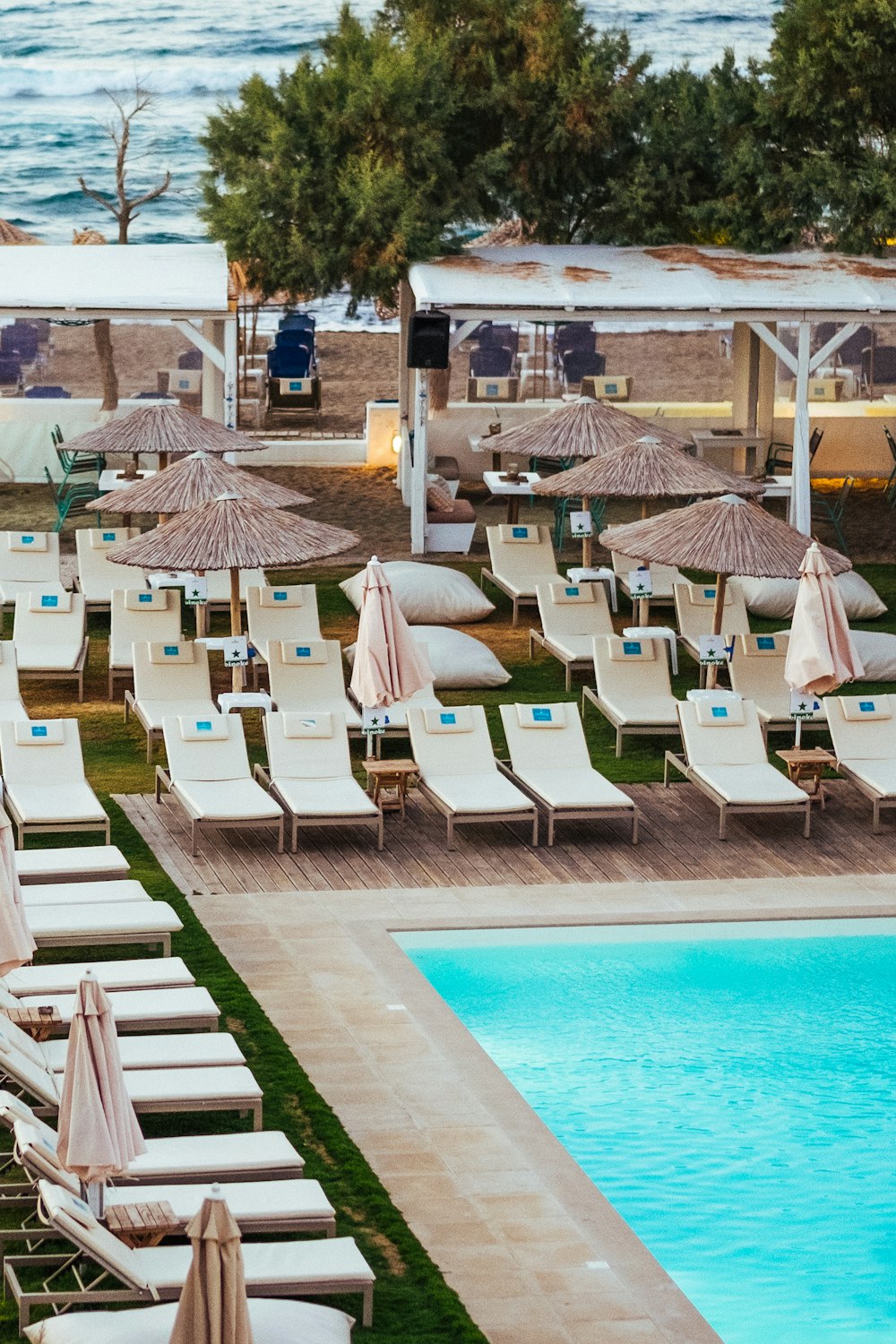 white sun lounge beside pool