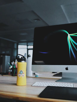 A vibrant workspace with a computer screen showing AI-generated art in progress.