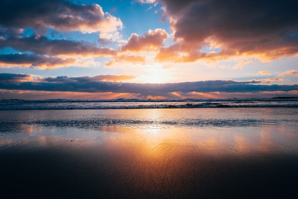 silhouette photography of body of water at golden hour