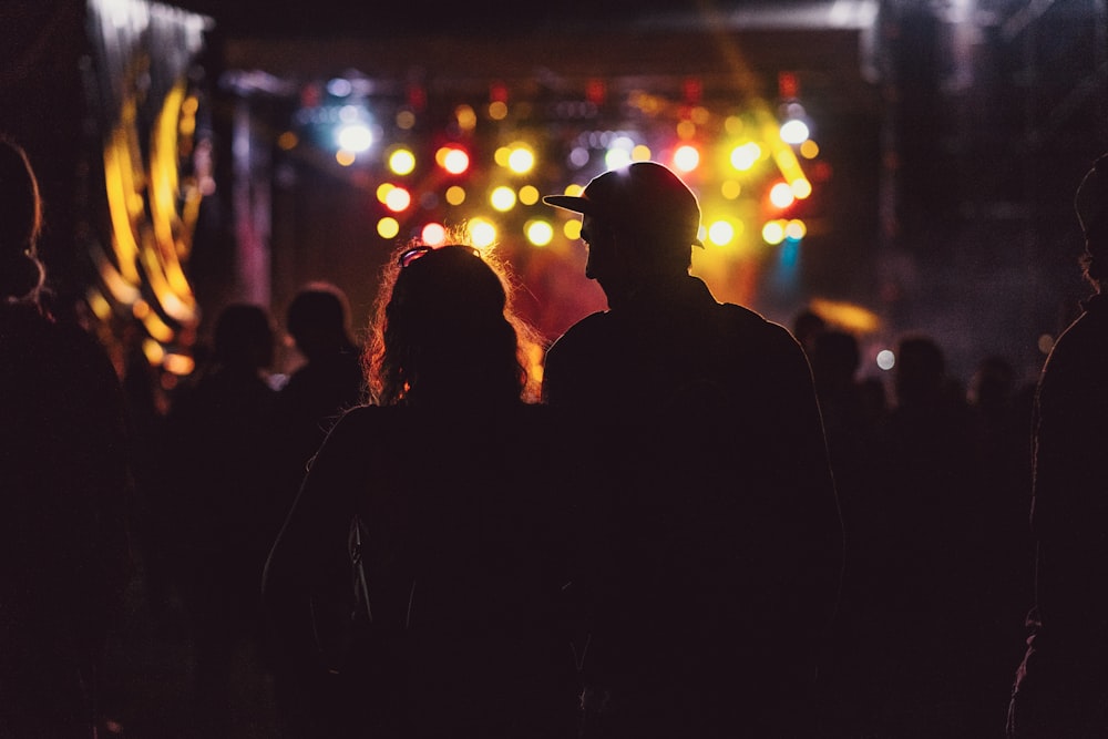 silhouette photo of a man and a woman on the stage