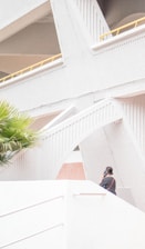 Architect Walter answering a phone call in a modern studio space.