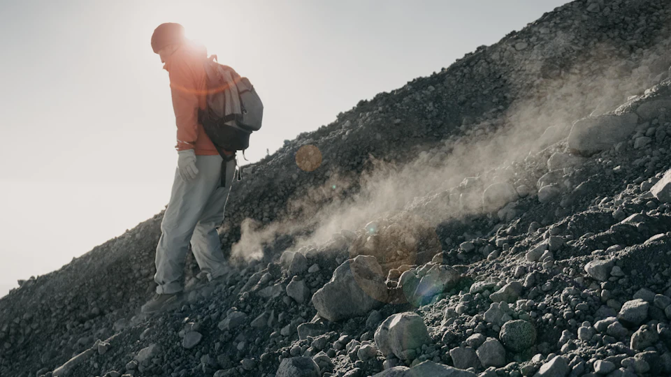 A person walking across exposed rock terrain