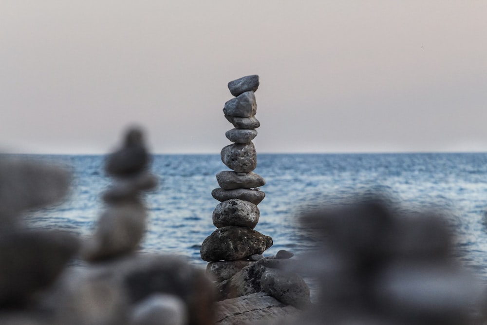 rock balancing near body of water