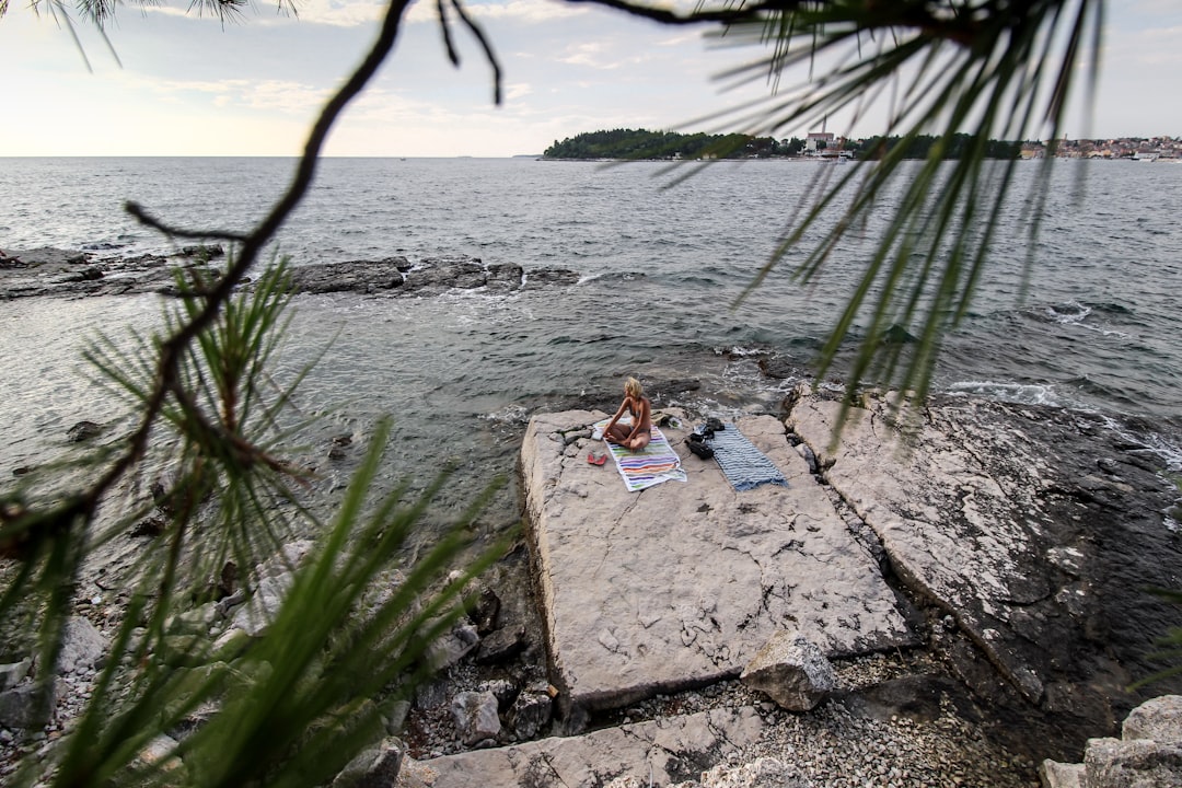 woman sitting on seashore, Rovinj, Istria, offers some of the most beautiful rocky beaches on the coastline of the Adriatic Sea.</p></figure><p>Shot by > www.instagram.com/valentinsalja