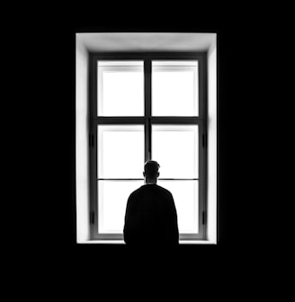 man standing in front of the window