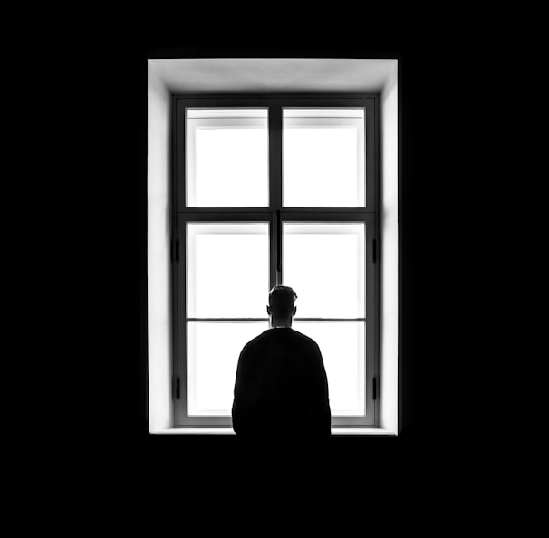 man standing in front of the window