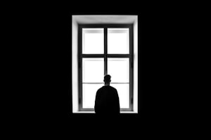 man standing in front of the window