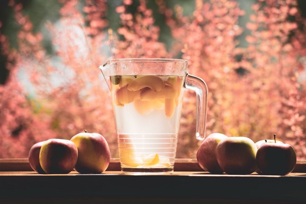 clear glass pitcher filled with clear liquid selective focus photography