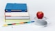 honeycrisp apple fruit near books and chalk Google Home Mini smart speaker