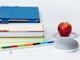honeycrisp apple fruit near books and chalk Google Home Mini smart speaker