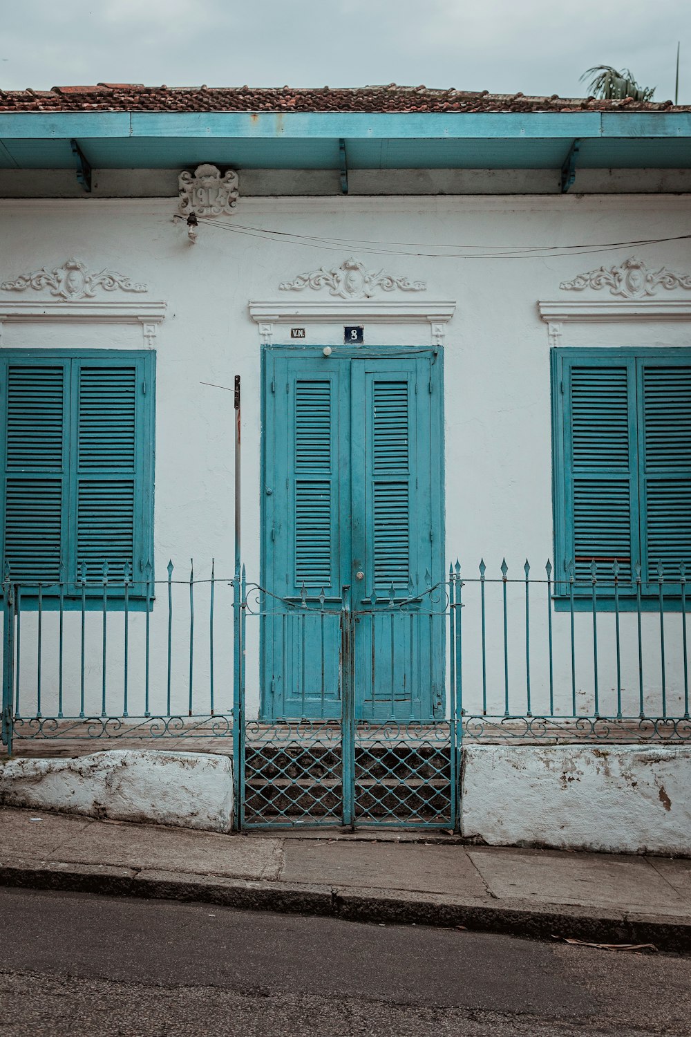 Weißes und blaugrünes Betonhaus tagsüber