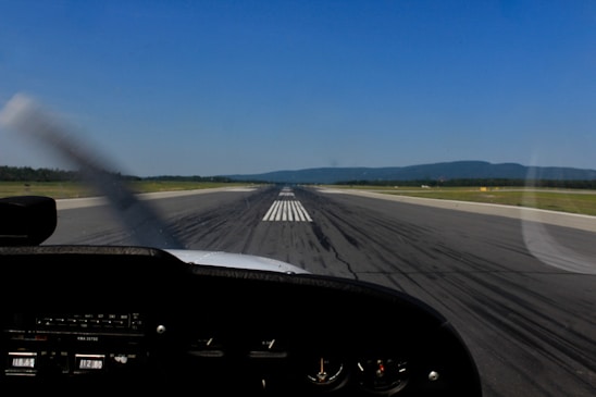 A professional pilot preparing a private aircraft for takeoff on a clear day.