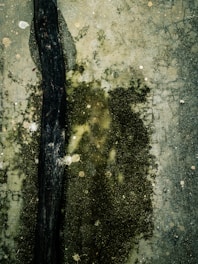 a black object sitting on top of a dirty floor