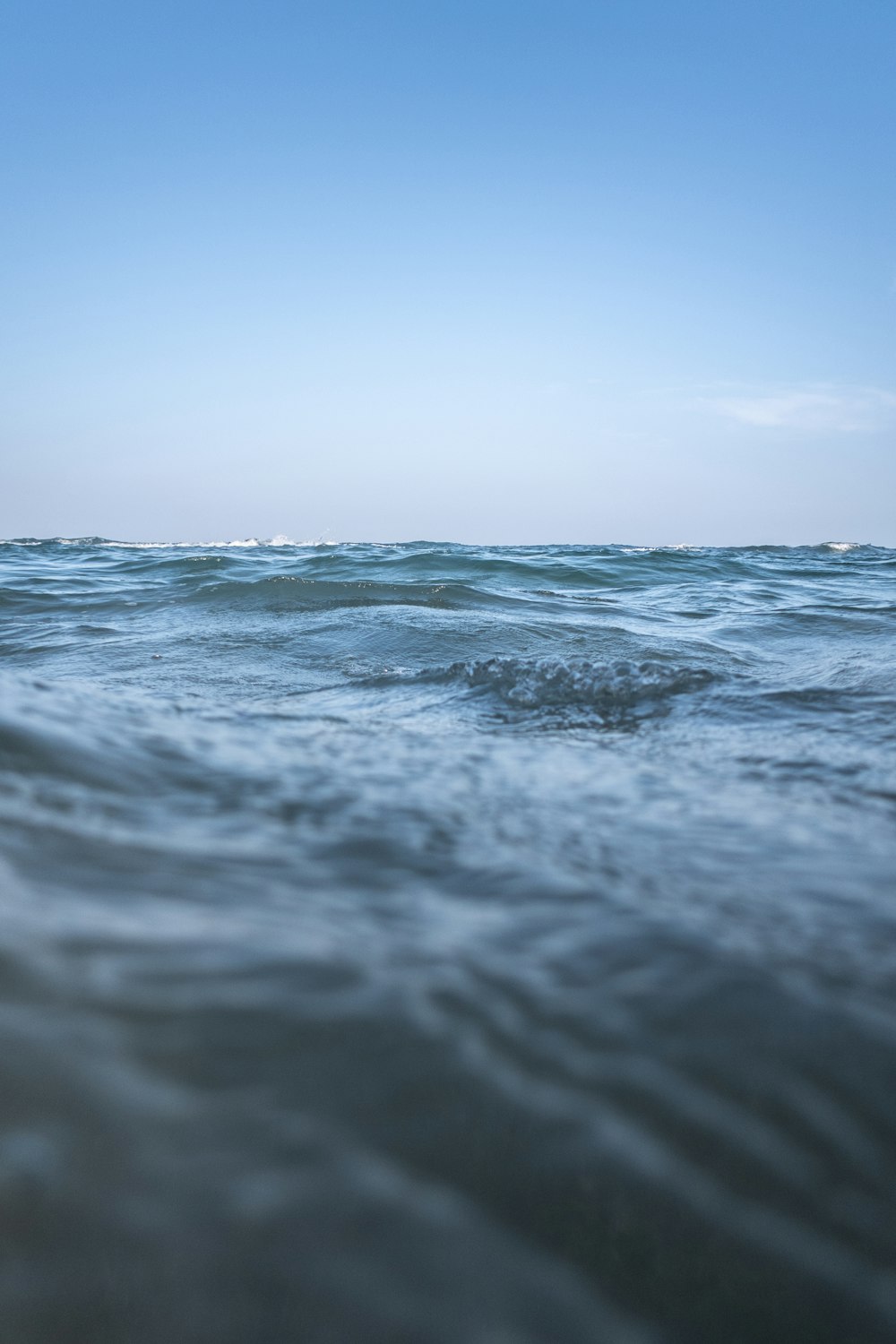 body of water under clear blue sky