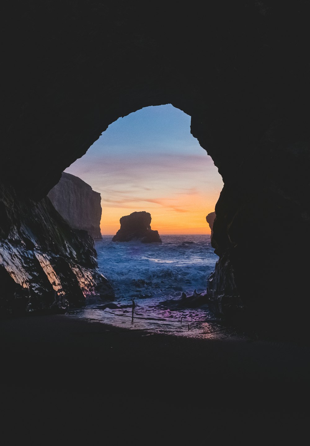 body of water near cave