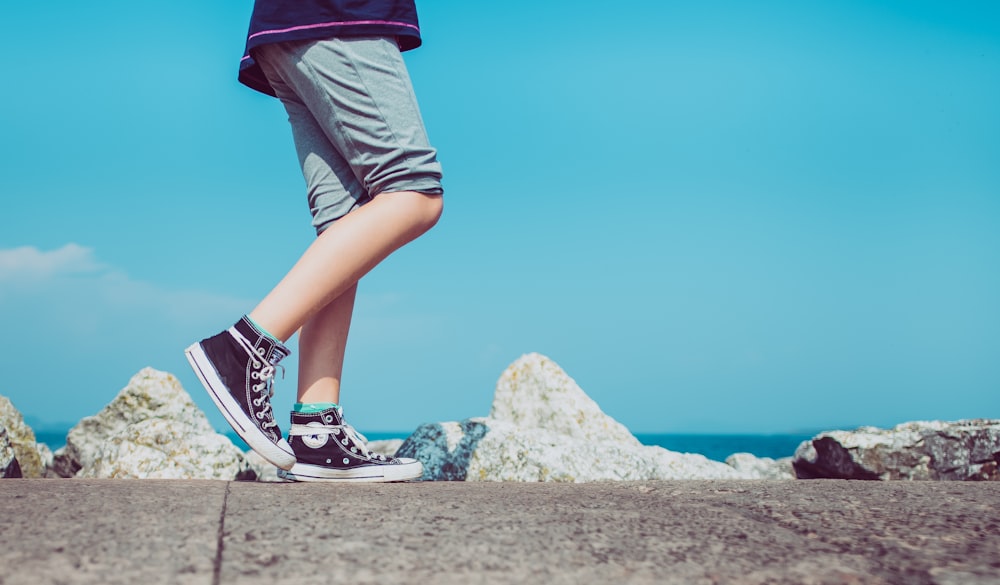 person walking on gray concrete pavement