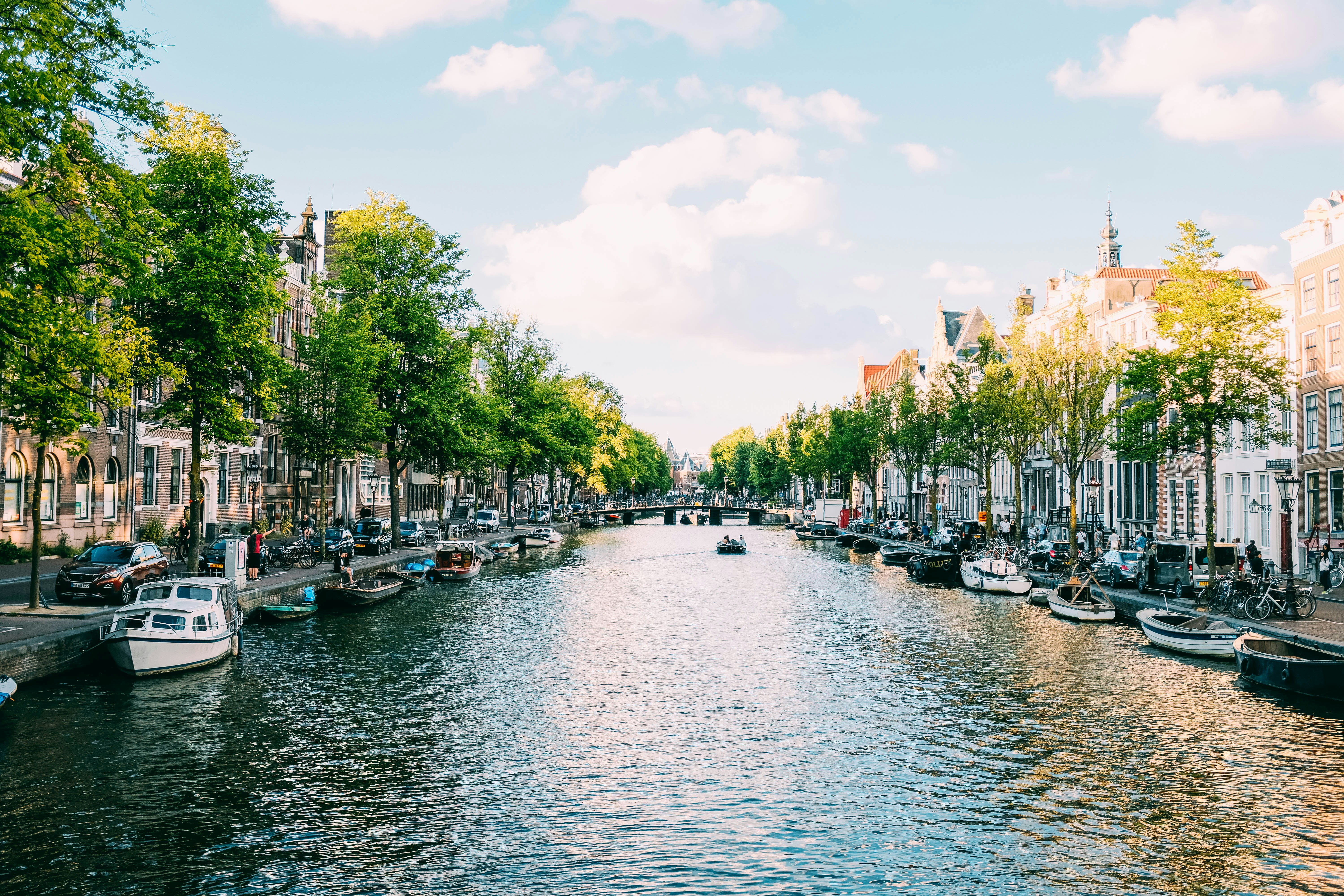 Sunny Amsterdam canal in spring with traditional Dutch houses