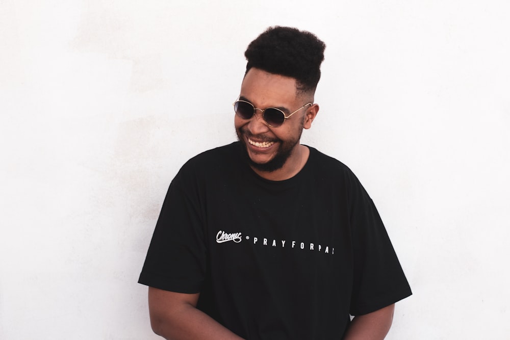 smiling man wearing black t-shirt